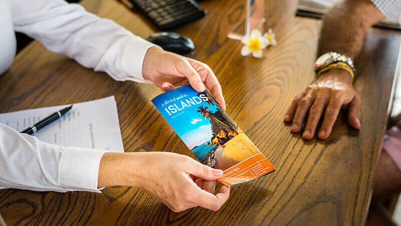 travel brochure held over desk