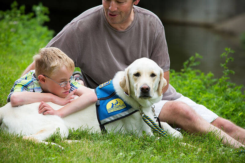 Adult and child with service dog