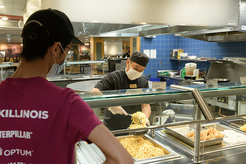 student, food server, both in masks