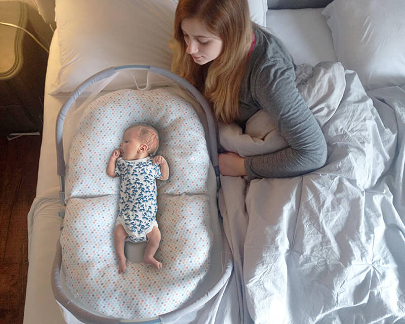 baby sleeper in bed with parents