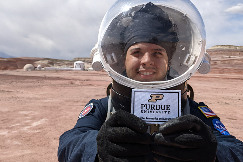 grad student in space suit outside habitat