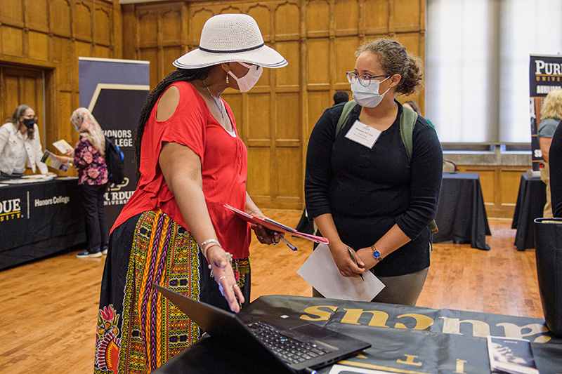 conversation at new faculty Information Fair