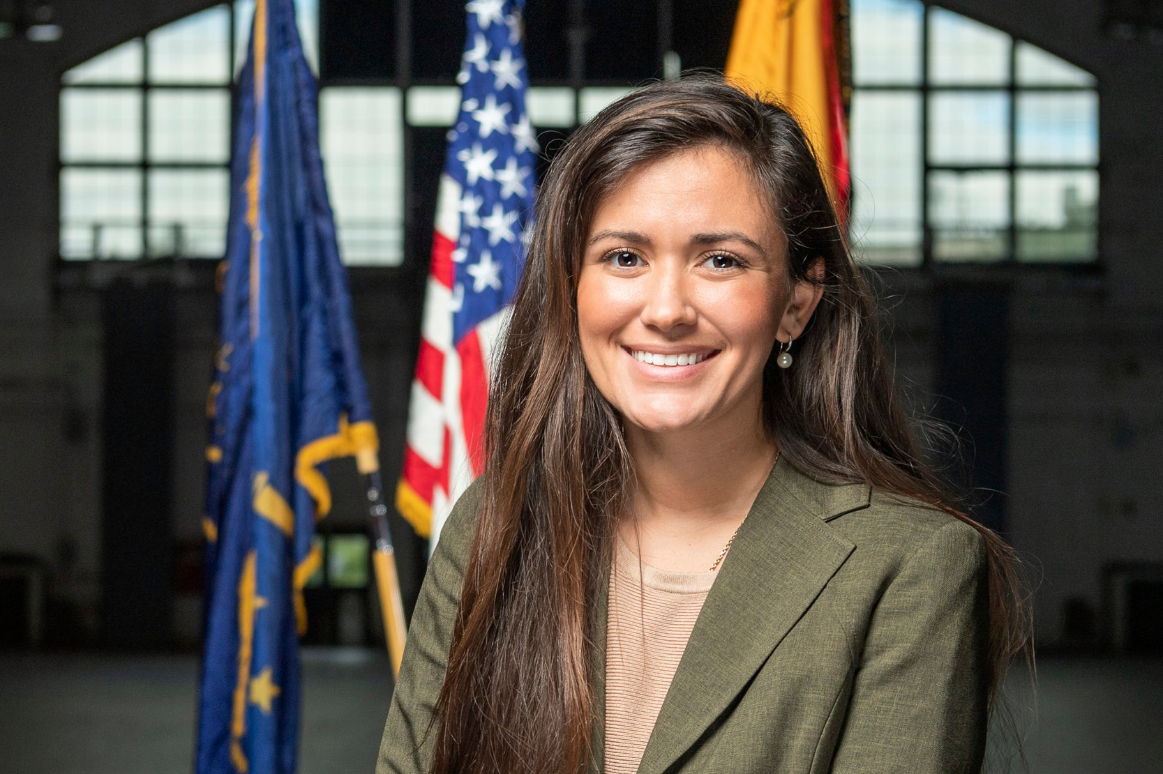 Sgt. Morgan Torres with flags in Armory