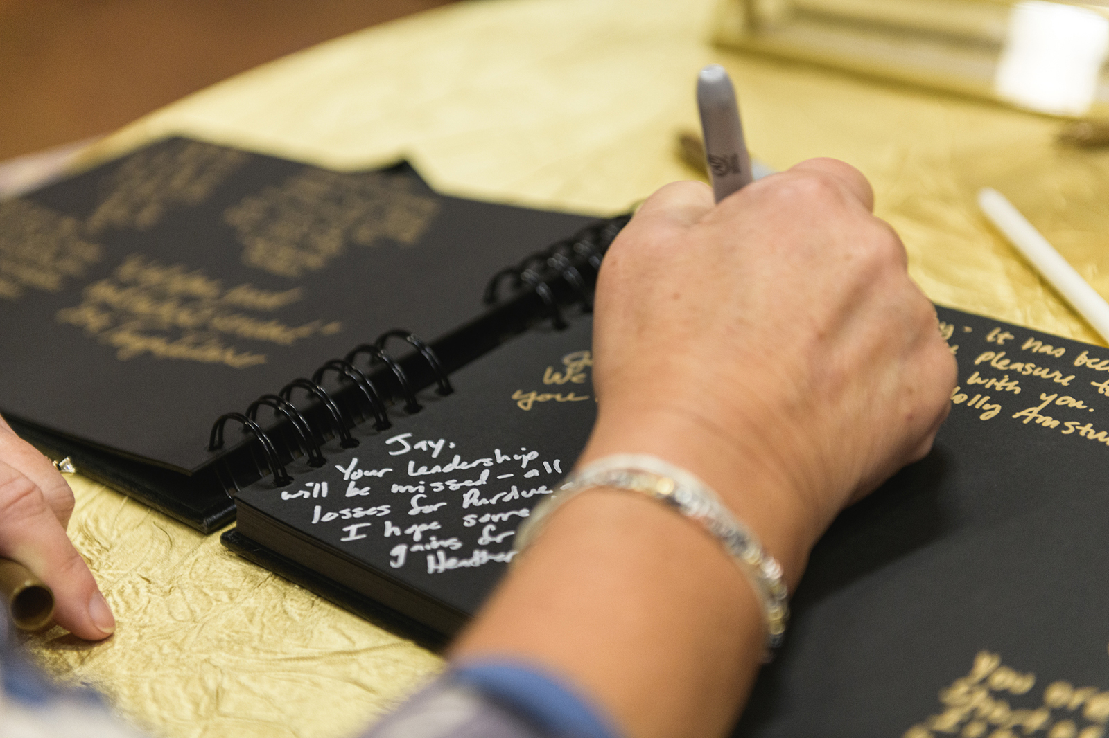 Guest writing in book of well wishes