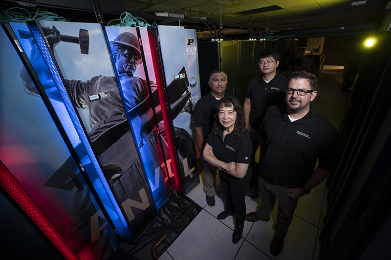 People standing by Anvil supercomputer
