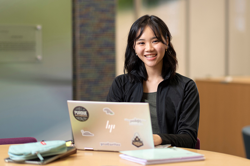 student in learning community at computer