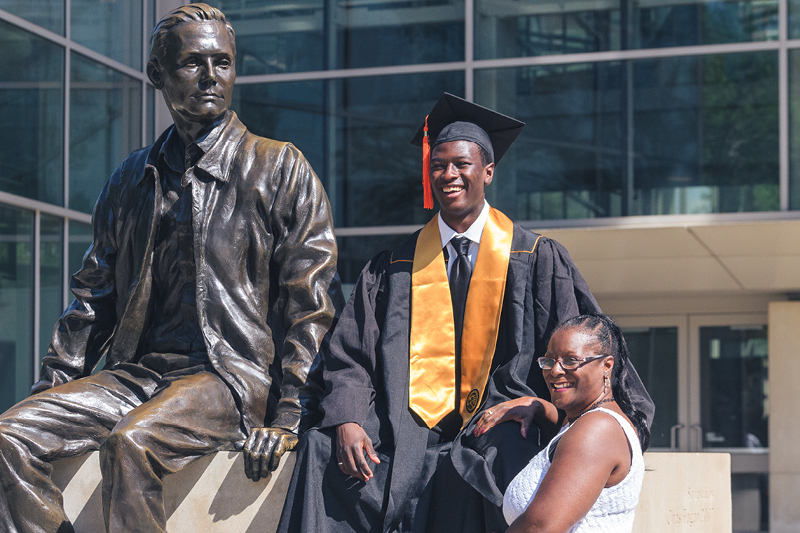 Family taking photo by Neil Armstrong statue