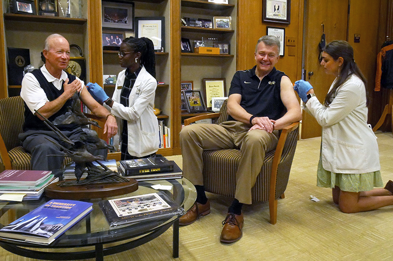 President Daniels and Provost Akridge getting flu shots