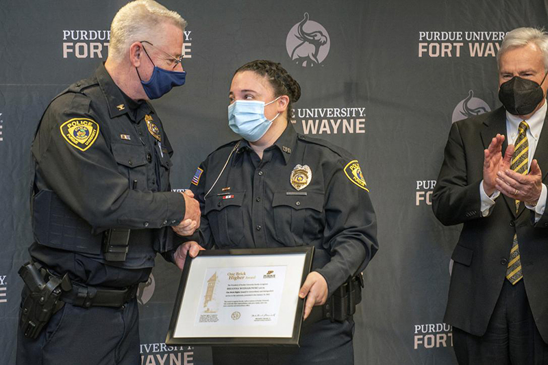 Officer Wojnarowski receiving award from Chief Cox