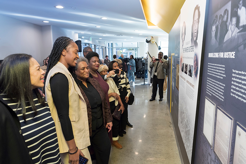 People looking at Parker sisters commemorative installation 