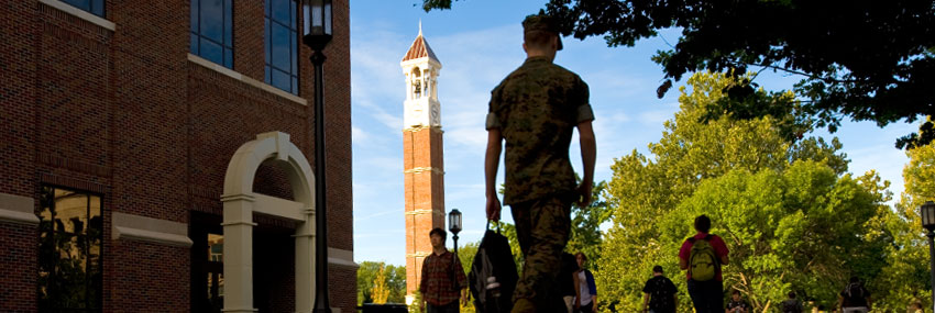 Military student walks near Purdue bell tower