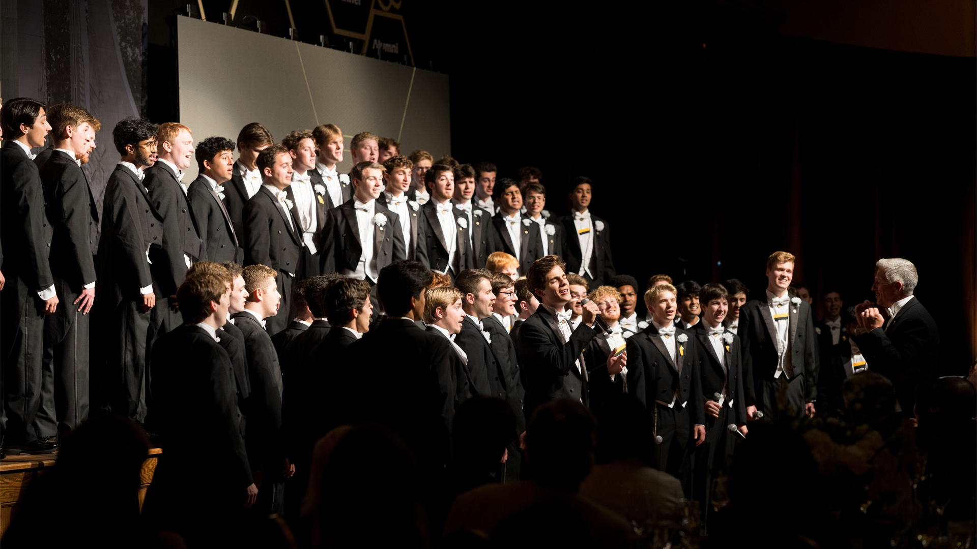 A photo of the Glee Club performing in front of the alumni and students celebrating 150 years of Engineering at Purdue