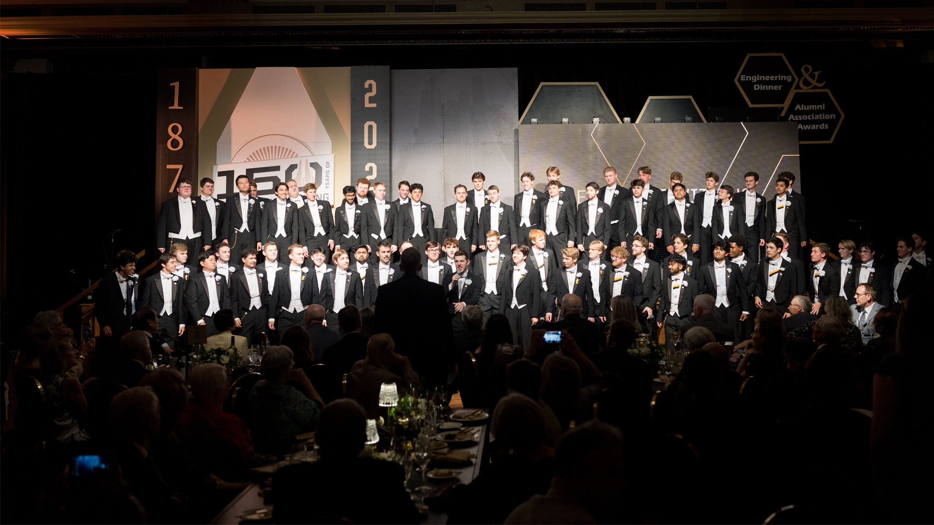 A photo of the Glee Club performing in front of the alumni and students celebrating 150 years of Engineering at Purdue