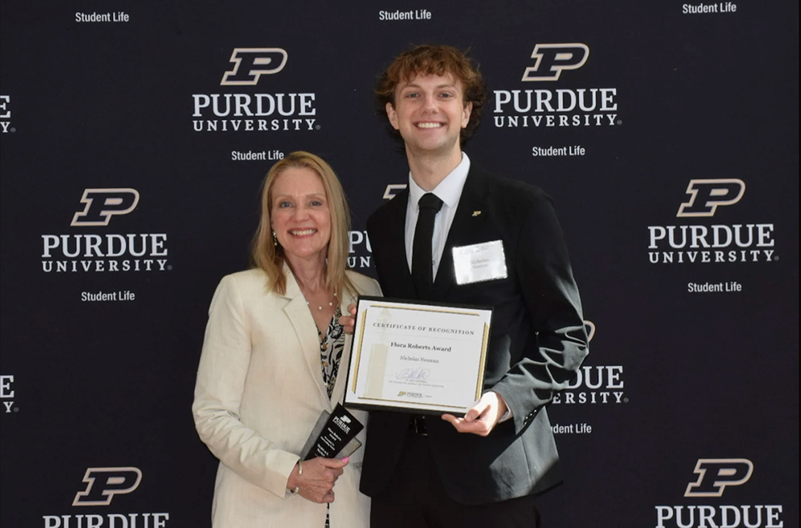 Nicholas Neuman pictured receiving his Flora Roberts award with Beth McCuskey in the spring of 2026..