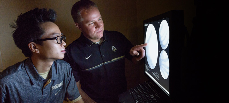 Photo of teacher and student viewing xrays together
