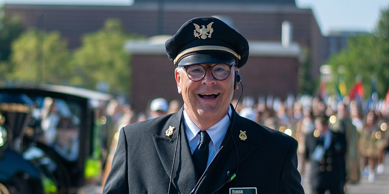Jay Gephart leads the band during a gameday parade around campus.