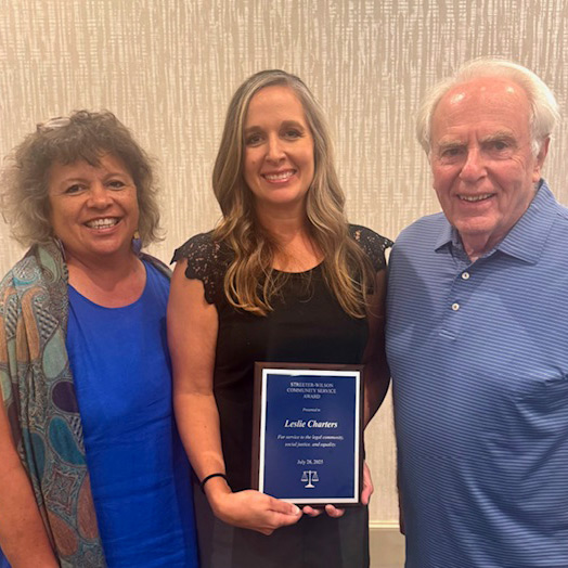 Leslie Charters holding her award