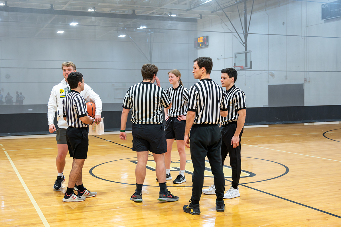 Officials standing together on the court