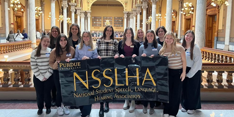 Students holding a banner for NSSLHA