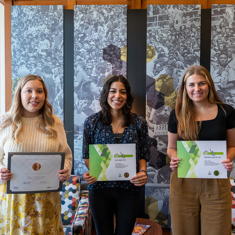 Kayla Clark, Karla Alvarado and Taylor Thomas standing with their ADDY Awards