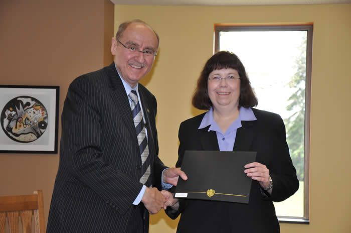 Photograph of 2014 award recipient Jane E. Rose receiving award certificate from James B. Dworkin